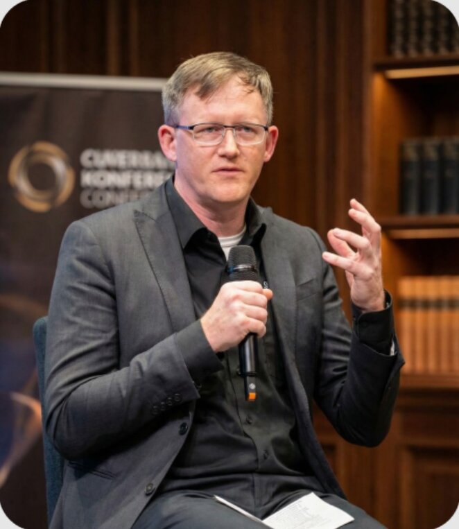 Orion Media speaker answering questions at a conference